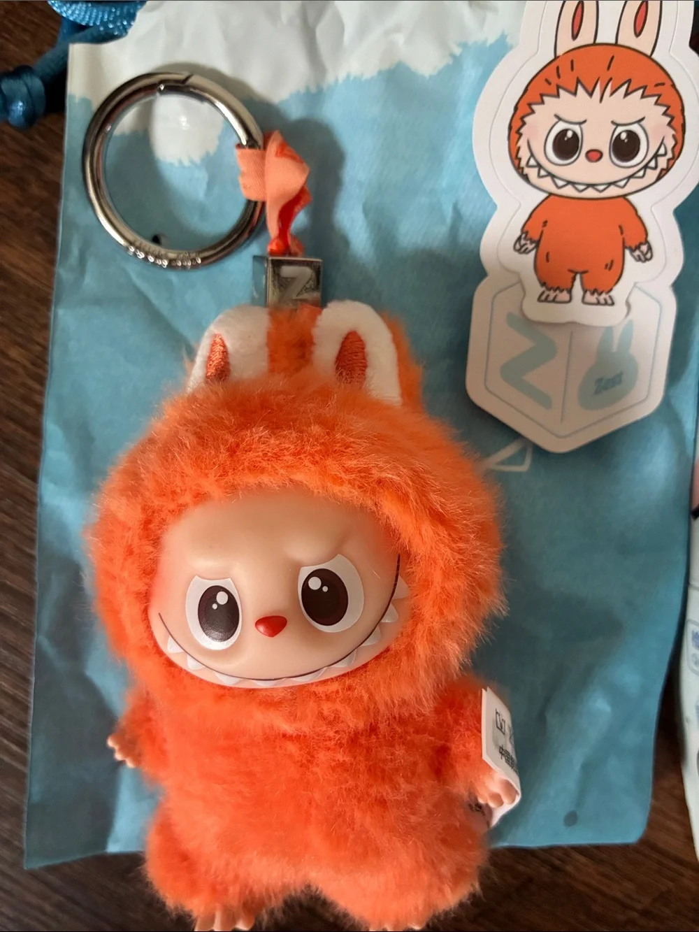 Popmart The Monsters Keychain and a unbranded capybara plush crossbody with pen